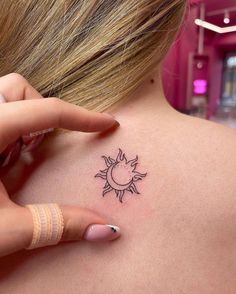 a woman with a small sun tattoo on her back