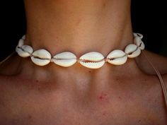 Cowrie shell choker necklace made by hand, using ivory color waxed thread, 100% waterproof and washable, you can even enjoy the necklace while taking a swim!Necklace can be worn in different lengths to fit your each time needs. Adjustable closure that tightens and looses with ease for an excellent fit. Just pull the endings and the necklace will close on the length you wish.Consists of natural pieces of cowrie shells, plus two smaller shells as a decorative touch, at the endings of the necklace.