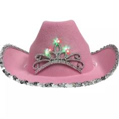 a pink cowboy hat with a tiara on the brim and sequins