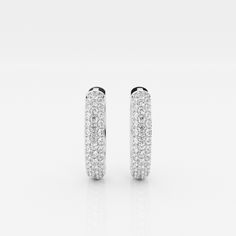 The Bombë Micro Huggie is a luxurious take on an everyday favorite. A miniature version of a classic hoop earring, these 14K gold diamond huggie earrings exude elegance and contemporary style. Three rows of lab grown pave diamonds embellish the curved shape of the earrings, encouraging you to dazzle from every angle. Luxury Oval Huggie Earrings For Everyday, Luxury Dazzling Round Huggie Earrings, Luxury Diamond Halo Hoop Earrings, Classic Diamond Huggie Earrings With Pave Setting, Classic Hoop Huggie Earrings With Pave Setting, Classic Huggie Earrings With Round Cut Pave Setting, Luxury White Hoop Earrings With Brilliant Cut, White Hoop Diamond Earrings With Single Cut, Luxury White Brilliant Cut Hoop Earrings