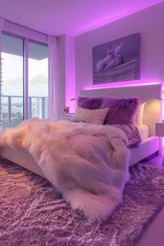 a bedroom with purple lighting and fur rugs on the floor in front of large windows