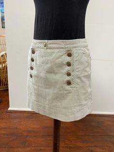 This little skirt is beautifully made in a cotton ticking fabric, and has lovely pocket and button detail.  It is mostly cotton with 3% elastane, and is a French size 40 (UK 12). Waist 85cm Length from waist to hem 40cm Fitted Cotton Mini Skirt With Pockets, Cotton Mini Skirt With Lining, Relaxed Cotton Skort Of Short Length, Short Length Cotton Skort With Relaxed Fit, Short Cotton Skort With Pockets, Cotton Mini Skirt With Pockets, Cotton Mini Skort With Pockets, Cotton Mini Bottoms With Buttons, Fitted Cotton Skirt With Buttoned Pockets