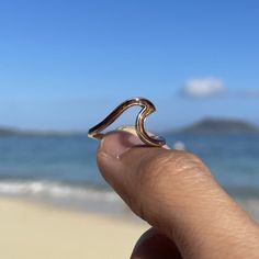 Add a touch of natural elegance to your jewelry collection with our Koa Wood Wave Ring. This stunning ring features a beautifully crafted wave design in 925 solid sterling silver, paired with a band made of authentic Koa wood. Crafted with precision and care, this ring is comfortable to wear and perfect for all occasions. Its minimalist design makes it suitable for any outfit, whether you're at the beach or going about your daily routine. Koa wood is a native wood of Hawaii and is known for its strength, durability, and natural beauty. This ring is a reminder of the beauty and resilience of nature and the importance of preserving our natural resources. Our Koa Wood Wave Ring is an excellent gift for anyone who loves the charm and mystique of Hawaii. Priced affordably, it's a thoughtful and Hawaiian Jewelry, Koa Wood, Wave Ring, Wood Ring, Silver Plated Jewelry, Wood Rings, Wave Design, Stackable Rings, 925 Sterling Silver Jewelry