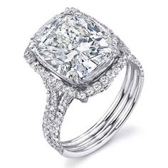 an engagement ring with a cushion cut diamond in the center and two rows of diamonds around it