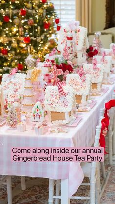 a table covered with lots of cakes and cupcakes next to a christmas tree