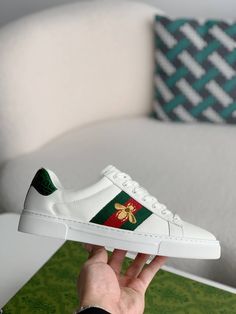 Step into iconic style with these Gucci Ace Embroidered Sneakers, a homage to Gucci's signature aesthetic. The crisp white leather upper is accented with the signature web stripe and a playful embroidered bee, adding a touch of whimsy and luxury. The metallic leather heel tab elevates the design, creating a classic and contemporary sneaker. Men's/ Women's Gucci Watch, Versace Watch, Low Heel Shoes, Platform Sneaker, Metallic Leather, Brunei, Watch Brands, High Quality Leather, Sneakers White