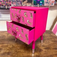 a pink dresser with zebra print drawers on it