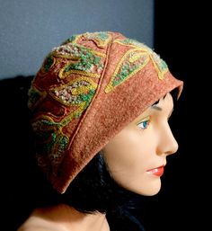 A 1920s reproduction, this hat is designed and hand-made by us here at VintageDressNCostume! Made from rust wool felt with an overall leaf design, this hat mimics its 1920's counterpart. It fits close to the head and is equally nice on short, long or bunned hair. Packs away easily. Has a sewn-in comb to keep in place. Includes a styrofoam wig-head to help keep its shape.      Great for Plays, Musicals, Music Reviews or Streetwear Dry Clean only. Shown here over a wig which is not included. Vintage Fitted Felt Hat For Fall, Fitted Felt Cap For Fall, Fitted Fall Felt Cap, Vintage Wool Cloche Hat For Fall, Vintage Fall Hats One Size, Vintage Fitted Beanie Hat, Vintage Felt Hats For Fall, Vintage Brown Felt Hat For Fall, Brown Vintage Felt Hat For Fall