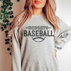 Gear up for success on and off the field with our Custom Baseball Team Sweatshirts, designed to unite your squad in style. Whether you're prepping for game day or celebrating a hard-fought victory, these sweatshirts are the ultimate symbol of team pride. Crafted from premium, ultra-soft fabric, our sweatshirts offer unbeatable comfort and durability, ensuring you stay warm and cozy during those chilly practices and post-game celebrations. But what truly sets them apart is their customizable design – you have the freedom to add your team's logo, name, or any other personalized details that represent your squad's identity. From Little League dreamers to seasoned veterans, our Custom Baseball Team Sweatshirts are perfect for players of all ages and skill levels. Whether you're huddling up in Softball Sweatshirt, Team Sweatshirts, Logo Name, Graphic Apparel, Baseball Team, Crew Sweatshirts, Shirt Ideas, Team Spirit, The Field