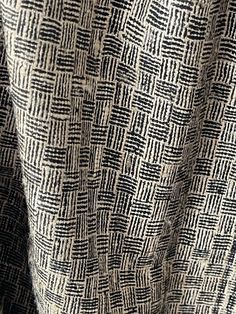 an up close shot of a black and white patterned fabric