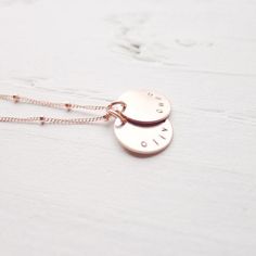 "I am in love with the color of rose gold! I'm excited to offer my best selling necklace in this warm, luxurious metal! The names of your choosing are hand stamped on rose gold filled medallions and lay on a delicate beaded rose gold filled chain. . { d e t a i l s } . Made to order. rose gold filled. . { m e a s u r e m e n t s } . 1/2\" disc 16 or 18\" in length . { o p t i o n s } . Please leave personalization preference in the notes to camileedesigns field at checkout This design in traditi Rose Gold Tarnish Resistant Charm Necklace For Anniversary, Personalized Dainty Rose Gold Charm Necklaces, Personalized Dainty Rose Gold Charm Necklace, Adjustable Rose Gold Charm Necklace With Custom Name, Minimalist Rose Gold Hand Stamped Charm Necklaces, Minimalist Rose Gold Hand Stamped Charm Necklace, Minimalist Hand Stamped Rose Gold Charm Necklace, Adjustable Rose Gold Everyday Necklace, Adjustable Rose Gold Necklace For Everyday Wear