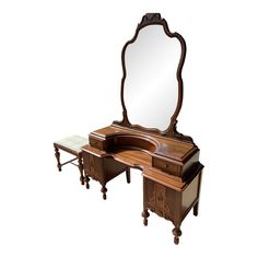 an antique dressing table with mirror and stool