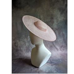 One cartwheel sinamay straw hat base in rose petal pink blush that measures approximately 15" (38cm) in diameter. Crown is 1.5" (3.8cm) high. The edges of the brim are finished in wired sinamay. The multi-layer stiffened sinamay straw has a great sturdy weave and provides excellent support for your millinery creations. Sinamay is a natural material and you will see occasional beige / brown fibers / striations in the weave. This is not a defect, but is the result of how different natural fibers respond to dye and processing. This is NOT a ready to wear finished hat and will not stay on your head unless you add a head band or elastic to wear. Add embellishments of your choice.  A nice high quality base - I know you'll be pleased! This hat base is listed separately in over a dozen different c Fitted Felt Hat With Flat Crown For Spring, Fitted Top Hat With Flat Crown For Spring, Elegant Felt Hat With Flat Crown For Spring, Elegant Spring Felt Hat With Flat Crown, Elegant Spring Top Hat With Flat Crown, Spring Adjustable Flat Crown Top Hat, Spring Adjustable Top Hat With Flat Crown, Formal Flat Crown Panama Hat For Spring, Elegant Spring Sun Hat With Flat Crown