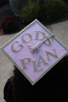 a person wearing a graduation cap with the words god's plan written on it