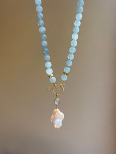 This elegant eye-catching beaded necklace is made of natural aquamarines (AAA quality) and embellished with beautiful baroque pearl pendant settled on an aquamarine charm and gold vermeil toggle clasp. It will become a wonderful gift idea, especially for those who are born in March, as aquamarine is the birthstone for March.  MATERIAL Aquamarine, gold vermeil, freshwater pearl  SPECIFICATIONS Length 46 cm (18 inches) Beads are 8 mm Handmade in Spain Necklace comes in a gift box Worldwide shipmen Gold Vermeil Jewelry, Gemstone Necklaces, Toggle Necklace, Baroque Pearl Necklace, Aquamarine Jewelry, Vermeil Jewelry, Beaded Choker Necklace, Pearl Charms, Necklaces For Women