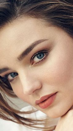 a close up of a woman with blue eyes