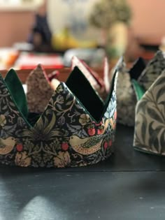 three crowns sitting on top of a table