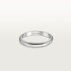 a white gold ring with the word cartier engraved on it's side, in front of a plain background