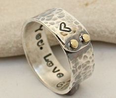 a silver ring with two hearts on it