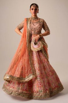 Premium Pakistani Bridal Dress in Organza Choli Lehenga Style is adorned with hand-crafted details of dabka, gota, kora, naqshi, and threads. The choli has an alluring pink shade and the Bridal Lehenga is multi-colored, creating a lavish Lehenga Dress for the bride to wear on the big day. Pink Chanderi Dress With Intricate Embroidery, Pink Raw Silk Set With Zari Work, Pink Tissue Silk Set With Zari Work, Pink Traditional Wear With Gota Work For Designer Occasions, Traditional Pink Raw Silk Dress, Pink Art Silk Choli With Zari Work, Pink Tissue Silk Choli With Resham Embroidery, Pink Raw Silk Embroidered Fabric For Reception, Traditional Pink Silk Dress