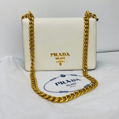 Free Authentification! New Prada - Chain Flap Bag Saffiano Leather * White And Black Leather * Gold Hardware * Crossbody * 8"W X 6"H X 2"D12" Handle Drop21" Strap Drop Classic White Shoulder Bag With Gold-tone Logo, Classic White Bags With Logo Plaque, Elegant White Shoulder Bag With Logo Plaque, Chic White Bag With Gold-tone Logo Plaque, Designer White Bags With Gold-tone Logo Plaque, Luxury White Shoulder Bag With Logo Plaque, Designer White Bags With Gold-tone Logo, White Leather Bags With Logo Plaque, White Shoulder Bag For Evening With Original Box