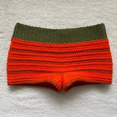 🎃Hand crocheted Halloween Themed Black & Orange Mini Shorts. Please note that these shorts are mini shorts, if you message me I can adjust the length to make them slightly shorter or longer. 🎃 🎃The shorts waist band is made with a soft green yarn and hugs your waist but is stretchable. The body of the shorts are made with a soft orange yarn and a soft darker orange yarn. 🎃 🎃The shorts in the picture are a size Small. 🎃 Fitted Crochet Short Bottoms, Fitted Crochet Cotton Shorts, Fitted Cotton Crochet Shorts, Shorts Beach Outfit, Crocheted Halloween, Green Yarn, Halloween Pajamas, Soft Orange, Crochet Shorts