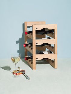 a wooden wine rack with several bottles in it