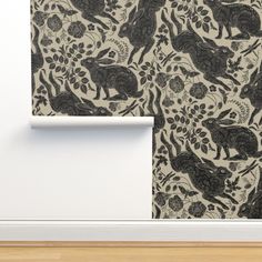 an animal themed wallpaper with black and white designs on the walls in a room