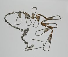 several pieces of metal that have been chained together with chains attached to them, on a white background