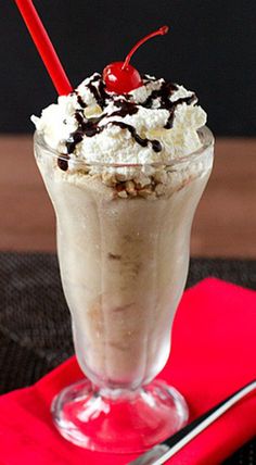 an image of a milkshake with whipped cream and cherries on the top