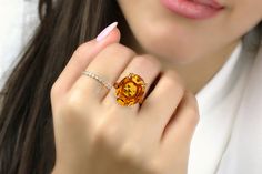 An adorable piece from Anemone's collection of birthstone rings for women. It features a stunning November birthstone, an oval-shaped Citrine set in 925 Sterling silver. With its magnificent color, this Citrine ring is sure to steal the show. Custom-made for you or your loved one's ring size. ☛ 𝒜𝐵𝒞 - Add Engraving - https://etsy.me/2ZSRjhu ☛ Ring size - Select the size you would like from the drop down menu ♥ Gemstone Type - Citrine (Heated) ♥ Gemstone Size - 16x20mm ♥ Gemstone Cut - Faceted Oval Citrine Solitaire Jewelry, Luxury Oval Birthstone Ring With Gemstone Accents, Oval Crystal Ring With Accent Stones For Gift, Oval Citrine Birthstone Crystal Ring, Oval Citrine Crystal Ring With Birthstone, Luxury Oval Crystal Ring With Gemstone Accents, Oval Citrine Diamond Promise Ring, Oval Citrine Diamond Ring With Prong Setting, Luxury Oval Birthstone Ring