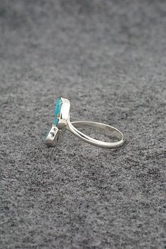 This turquoise and sterling silver heart-shaped ring was made by Zuni silversmith Gina Dosedo.Size: 8, adjustableLength: 5/8"Width: 3/8"Free shipping on all orders! We ship with USPS and always include tracking. All orders ship within a day of payment.Returns are accepted up to 30 days after you receive your order. Just send us a message. Our shop offers cash back or store credit. The item must be returned in new condition. Adjustable Turquoise Open Ring For Wedding, Teardrop Turquoise Sterling Silver Rings, Sterling Silver Teardrop Turquoise Ring For Anniversary, Turquoise Teardrop Ring In Sterling Silver For Anniversary, Teardrop Turquoise Ring In Sterling Silver For Anniversary, Southwestern Sterling Silver Teardrop Ring, Adjustable Turquoise Ring With Inlay For Gift, Adjustable Inlay Jewelry Ring, Anniversary Turquoise Teardrop Ring In Sterling Silver