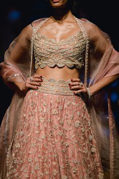 Editor's Note This set includes a peach lehenga paired with a matching dupatta and scallop hem blouse. The lehenga features intricate embroidery, while the net dupatta adds a delicate touch to the outfit. The blouse is designed to complement the lehenga and is also adorned with intricate embroidery. Color: Peach Fabric: Net; raw silk Components: Lehenga, blouse and dupatta Occasion: Engagement Disclaimer: Product color may slightly vary due to photographic lighting sources or your monitor settin Peach Sharara With Intricate Embroidery, Designer Peach Sharara With Intricate Embroidery, Designer Peach Lehenga With Intricate Embroidery, Bollywood Style Peach Sharara With Intricate Embroidery, Semi-stitched Peach Choli With Sheer Dupatta, Elegant Peach Lehenga With Dupatta, Peach Semi-stitched Choli With Sheer Dupatta, Semi-stitched Peach Lehenga With Sheer Dupatta, Peach Lehenga With Sheer Dupatta, Semi-stitched