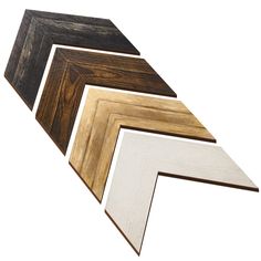 four different types of wood are arranged in the shape of an arrow, on a white background