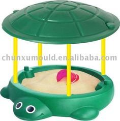 an animal sandbox with a turtle on top