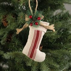 an ornament hanging from a christmas tree with red and white stockings on it