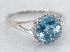 This white gold ring is a sparkling dream with its round cut blue topaz and diamond halo. Shine bright and stand out from the crowd with this unique and stunning piece of jewelry. Perfect for every occasion, it will add a touch of glamour to any outfit. Metal: 14K White Gold Gem: Blue Topaz 1.00 Carats Gem Measurements: 7.0 mm, Round Accents: 18 Diamonds totaling .08 Carats, SI-I in Clarity, H-I in Color Ring Size: 6 Marks: "14K 585" Stamped on the inside band SKU #: A40769 Each piece has been i Diamond Halo Ring, Ring With Diamond, Watch Chain, Halo Diamond Ring, Ring Diamond, Blue Topaz Ring, Color Ring, Halo Ring, Diamond Halo