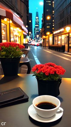 a cup of coffee sitting on top of a table next to a potted plant