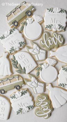 decorated cookies are arranged in the shape of an apple, truck and monogrammed names