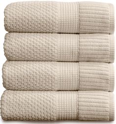 four white towels stacked on top of each other