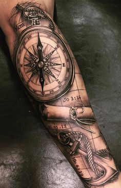 a man with a compass tattoo on his arm