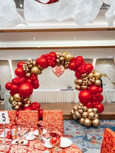 Red and gold balloon arch for New Year’s Eve wedding