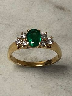 14kt Yellow Gold Lady's Diamond and Emerald Ring consisting of 1- 7mm x 5mm Genuine Oval Emerald Gemstone 3/4ct approx. total weight with 6 full cut round brilliant diamonds .30ct total weight SI1 clarity, G color all prong set in solid setting in finger size 6 3/4. This classic style ring can be resized for an additional $95.00 upon request. Emerald is the birthstone for May. This item would Retail for $3,145.00 Diamond And Emerald Ring, Smaragd Ring, Emerald Stone, Pretty Rings, Emerald Gemstone, Brilliant Diamond, Emerald Ring, Unique Engagement Rings, Round Brilliant