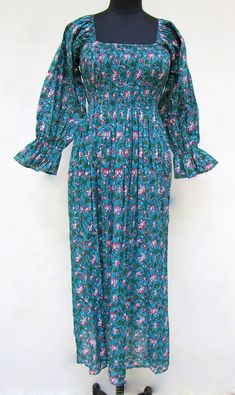 ITEM DESCRIPTION summer blue floral printed women's maxi dress - square neckline with smocked Indian dress - long ruffle sleeve bohemian maxi  Features: Long sleeve, square neck, Long dress Fabric : 100% Cotton cambric hand block printed fabrics  Sleeve Length = 22 inch For more sizes & their measurement, please refer our below chart to understand the sizes variations available with us For your size requirement, please mention your size in seller note at the time of buying. IMPORTANT NOTE: - SIZE MEASUREMENT AND CHARTS ARE OF THE ACTUAL GARMENT AND OF THE PERSON WEARING THE GARMENT. BUST MEASUREMENT IS PROVIDED IN INCH ALL AROUND FROM ARMPIT TO ARMPIT OF THE GARMENT. SIZE MEASUREMENT  BUSTLENGTHSHOULDER XXS34 inch51 inch13.5 inch XS36 inch51 inch14 inch S38 inch51 inch14.5 inch M40 inch51 Blue Maxi Smocked Dress With Ruffles, Blue Square Neck Maxi Dress With Smocked Back, Blue Maxi Dress With Smocked Back And Square Neck, Blue Fitted Smocked Maxi Dress, Blue Ruffled Maxi Dress With Square Neck, Bohemian Smocked Dress With Gathered Sleeves, Blue Long Sleeve Smocked Summer Dress, Blue Long Sleeve Smocked Dress For Summer, Blue Maxi Length Smocked Dress