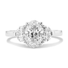 an oval cut diamond ring with three stone shoulders