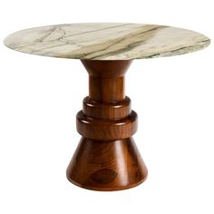 a marble topped table with wooden legs and an oval top, on a white background