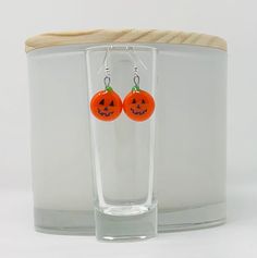 These orange pumpkin earrings will make you smile too.  A green stem tops these orange glass earrings.  Nichrome wire is fused between two layers of glass and polished after fusing.  Each pair of earrings will arrive on a display card in a white organza bag suitable for gifting. *Silverplated and goldplated earrings are hypo-allergenic. *French ball and fish hook earrings come with silicon backs. *Silver leverback earrings are interchangeable. *All earrings come with wires shown unless ordered differently. Orange Wire Wrapped Earrings For Gift, Fun Orange Earrings As A Gift, Fun Orange Earrings For Gift, Fun Orange Earrings For Gifts, Fun Orange Earrings For A Gift, Nickel Free Orange Halloween Earrings, Nickel-free Orange Earrings For Halloween, Orange Nickel-free Earrings For Halloween, Halloween Orange Nickel-free Earrings