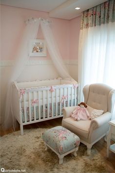 a baby's room with a white crib and pink walls