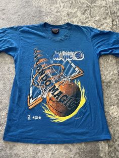 a blue shirt with an image of a basketball on it