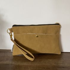 "A great size wristlet/clutch for your outings without having to carry around a large bag! Fits most standard wallets, a cell phone and some tubes of lipstick.  Handmade Includes faux leather wrist strap attached by gold d-ring One exterior pocket with magnetic gold snap 2 interior slip pockets Approx 8.5\" x 6\" Makes a great gift for bridesmaids, teachers, wives, girlfriends and more!" On-the-go Clutch With Removable Pouch, Rectangular Faux Leather Phone Bag With Zipper, Faux Leather Phone Bag With Zipper For Daily Use, Faux Leather Phone Bag Pouch For Everyday, Everyday Faux Leather Phone Pouch Bag, Crossbody Wristlet With Zipper For Daily Use, Daily Use Crossbody Wristlet With Zipper Closure, Daily Crossbody Wristlet With Zipper Closure, Chic Clutch Phone Bag With Zipper